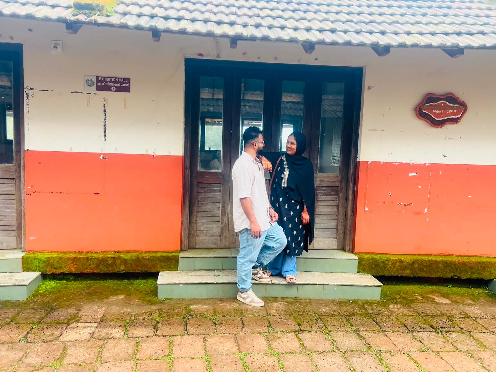 Fayiz and Shakkira standing together by a doorway